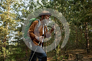 Mature man hiking and exploring forest nature enjoying cardio endurance