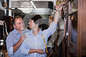 Mature man with his wife are shopping the old buffete