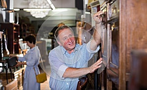 Mature man with his wife are shopping the old buffete