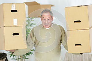 mature man holding boxes