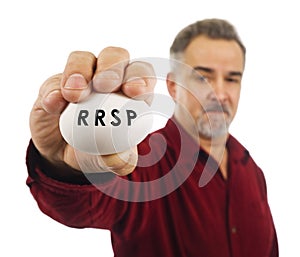 Mature man holds an egg with RRSP on it.