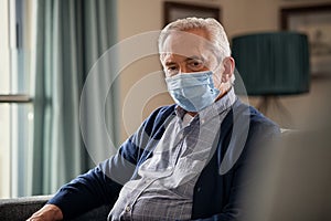 Mature man at home with mask