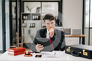 Mature man lawyer working and gavel, tablet, laptop in front, Advice justice and law concept. at office