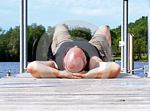 Mature man laying on the dock relaxing