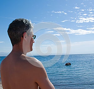 Mature man looking at sea