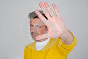 Mature man looking serious showing open palm making stop gesture