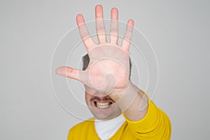 Mature man looking serious showing open palm making stop gesture