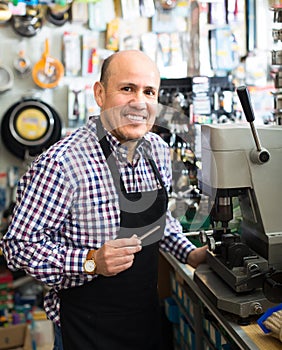 Mature man making duplicates of keys