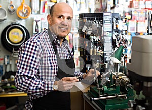 Mature man making duplicates of keys