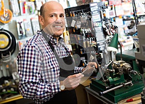 Mature man making duplicates of keys