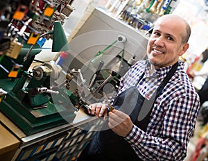 Mature man making duplicates of keys