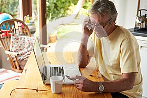 Mature Man Making On Line Purchase Using Credit Card