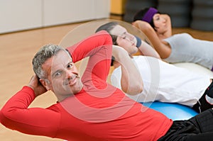 Mature man making sit-ups