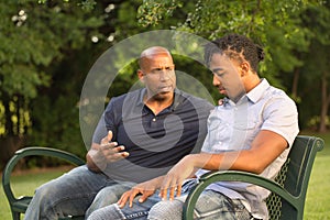 Mature man mentoring and giving advice to a younger man. photo