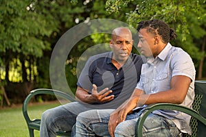 Mature man mentoring and giving advice to a younger man. photo