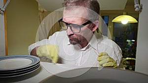 Mature man with obsessive compulsive syndrom cleans shelf of cupboard using q-tips. he tries to prevent infection. Front