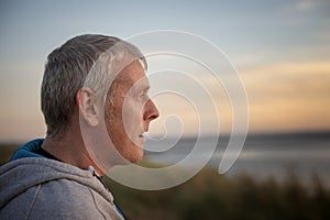 Mature man outdoors at sunset