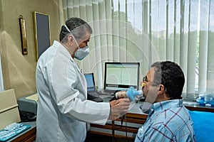 Mature man performing pulmonary function test and spirometry
