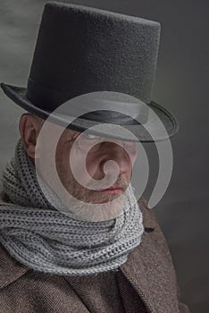 Mature man in period costume outfit with a top hat and grey scarf