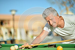 Mature man Playing billiard