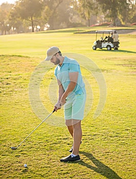 mature man playing golf game on green grass, golf swing