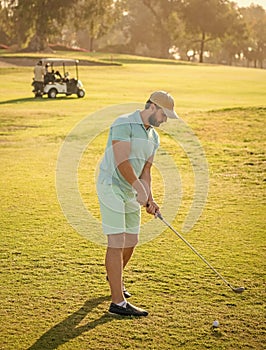 mature man playing golf game on green grass, golf swing