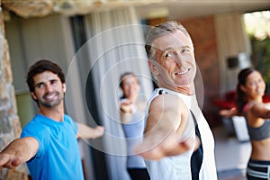 Mature man, pose and happy in yoga class for fitness and mental wellbeing, workout and daily lesson to coach people