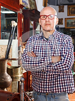 Mature man posing in antiques shop