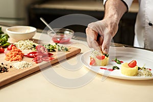 Mature man professional chef cooking meal indoors