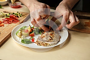 Mature man professional chef cooking meal indoors