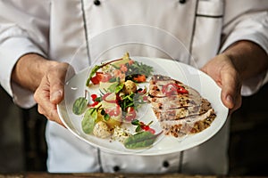 Mature man professional chef cooking meal indoors