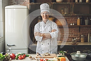 Mature man professional chef cooking meal indoors