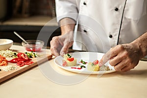 Mature man professional chef cooking meal indoors