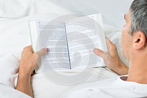 Mature man reading book