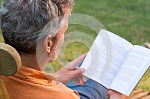 Mature Man Reading Book