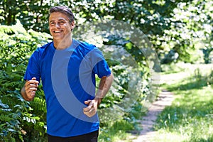 Mature Man Running Outdoors In Countryside