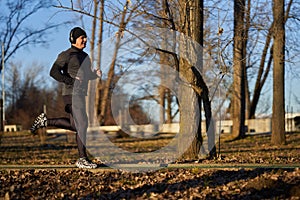 Mature man running in the park with headphones