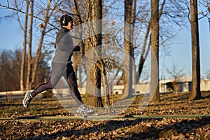 Mature man running in the park with headphones