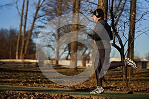 Mature man running in the park with headphones