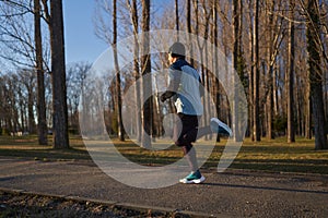 Mature man running in the park with headphones