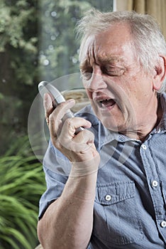 Mature man shouting into the phone