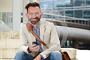 Mature man smiling with cellphone