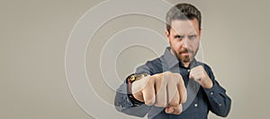 Mature man stand in offensive fighting position with clenched fist selective focus, power. Man face portrait, banner