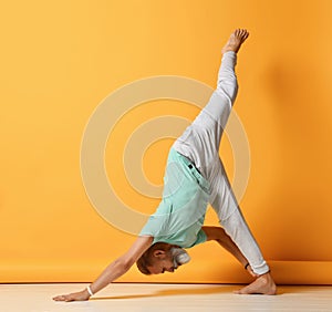 Mature man standing in inverted pyramid yoga pose