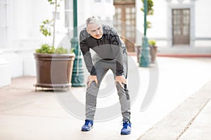 Mature man stopping for a breather after long run