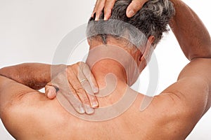 Mature Man stretching back of neck for pain relief