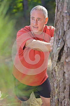 mature man stretching in park