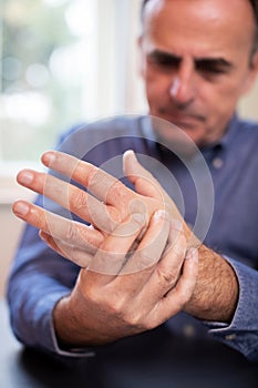Mature Man Suffering With Repetitive Strain Injury photo