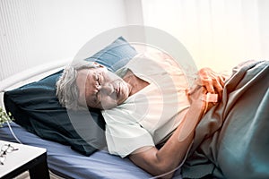 Mature man suffering from stomachache. Senior Patient on the bed and pain stomach at room in the hospital.