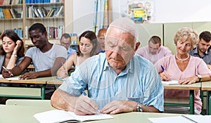 Mature man take a written exam